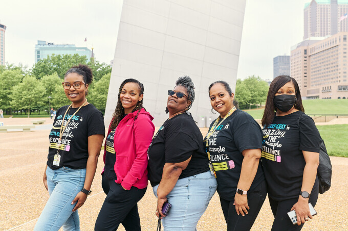 Elementary school educators pose in front of the Gateway Arch