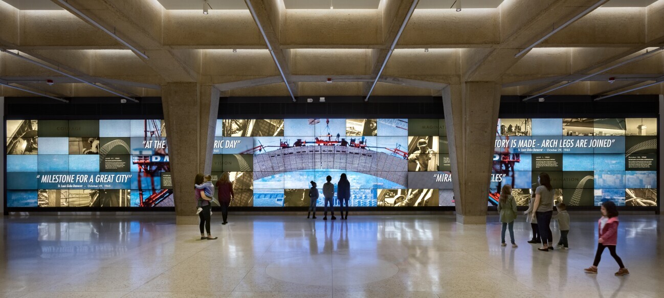 Video Wall - In the tram lobby, the video wall is a 100 ft. wide wall of monitors showing videos of the building of the Gateway Arch and scenes of American history and innovation, which are embodied in the Gateway Arch’s symbolism.
