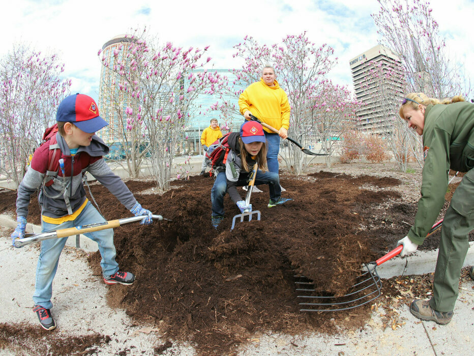 Boy Scouts digging mulch