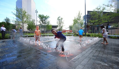 Children playing in splash pad at Kiener Plaza