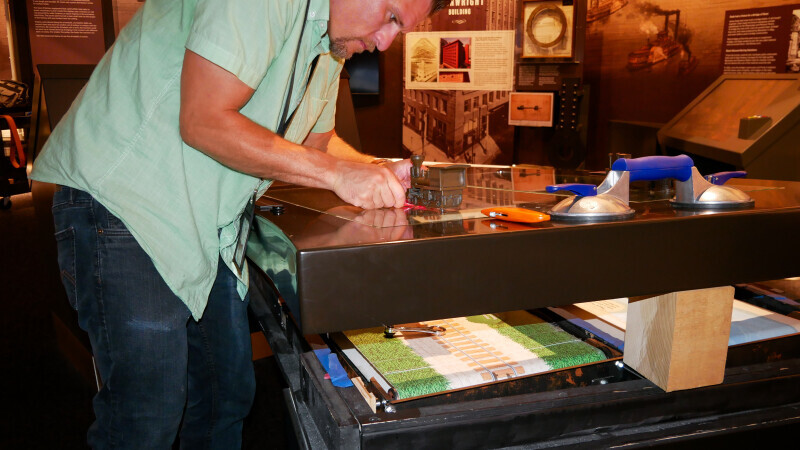 Man conducts museum maintenance at Gateway Arch National Park