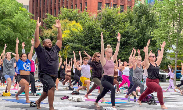 Participants practice yoga in Kiener Plaza